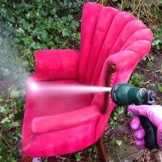 a pink chair being sprayed by a sprayer