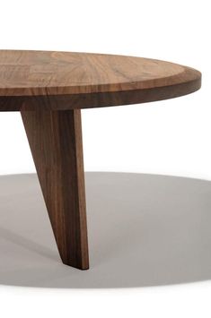 a wooden table with an oval shaped top