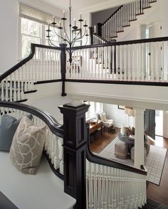 the staircase in this house is very large and has chandeliers on each side