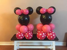 mickey and minnie mouse balloons on a table