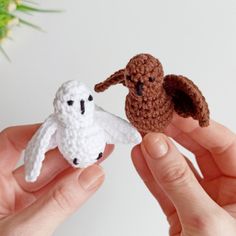 two small crocheted animals are being held in their hands, one is white and the other is brown