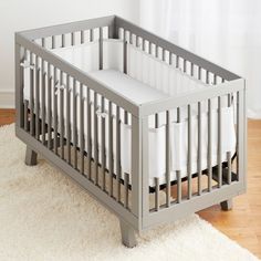 a baby crib in a room with white rugs