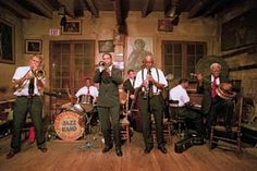 a group of men in suits and ties playing instruments