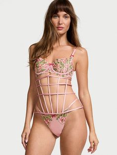 Show off your snatched waist and sexy curves with this underbust-style corset. Its edgy caged design is balanced beautifully with rosy-pink satin all around and is just right as a statement piece over dresses and button downs (or wear as part of a memorable lingerie look). Back hook-and-eye closures Hand wash Imported Pink Underbust Feminine Corset, Pink Feminine Underbust Corset, Feminine Pink Underbust Corset, Pink Underbust Corset With Boning, Pink Fitted Underwire Corset, Pink Strapless Corset With Boning, Pink Underbust Corset For Summer, Summer Underbust Pink Corset, Pink Strapless Corset With Boned Bodice