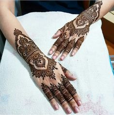 two hands with henna designs on them