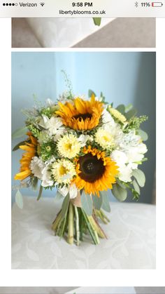 a bouquet of sunflowers and other flowers on a table