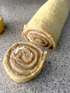 two cinnamon rolls sitting on top of a counter