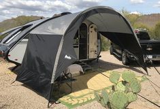 an rv is parked in the desert with its awning open and it's bed pulled up