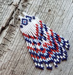 These beautiful red white and blue earrings are a perfect look anytime you are feeling patriotic. They measure 4.25" from the top of the earwire to the bottom of tip of the earrings and are 1" wide. Red Beaded Earrings For 4th Of July, Patriotic Dangle Beaded Earrings, Red White And Blue Beaded Earrings, Patriotic Beaded Dangle Earrings, Southwestern Blue Beaded Fringe Earrings, Rodeo Fashion, Beaded Fringe, Fringe Earrings, Blue Earrings