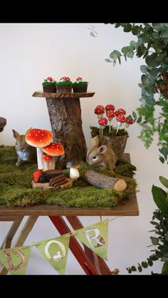 a table topped with lots of mushrooms and plants