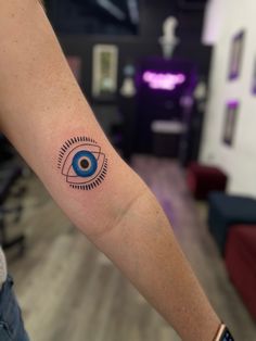 a person with a tattoo on their arm and an eye in the middle of his arm