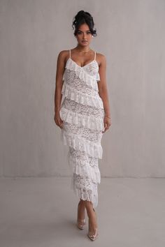 Designed for the JLUXLABEL Bridal Collection. Introducing the Ivory Feeling Of Forever Ruffle Dress, a masterpiece of elegance. Crafted from delicate lace with a nude underlining, this maxi dress exudes ethereal beauty. Its captivating ruffles cascade in an asymmetrical pattern, adding a touch of romance to your look. With a v-neckline and adjustable shoulder straps, it offers a flattering fit. Medium Stretch. Materials: 90% Nylon 10% Spandex (Contrast) 93% Nylon 7% Spandex(Lining) 94% Polyester Asymmetrical Pattern, One Shoulder Dress Long, Corsets And Bustiers, Dresses Xxl, Ethereal Beauty, Ruffled Maxi Dress, Curve Dresses, Runway Collection, Cami Dress