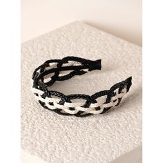 a black and white braided headband sitting on top of a table