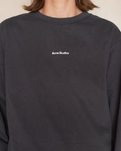 Logo longsleeve T-shirt by Acne Studios in black. Relaxed fit crewneck tee crafted from midweight cotton jersey. A wardrobe essential featuring the iconic logo stamped on the center front, adding a touch of contemporary chic. 100% Cotton.Made in Portugal. Sporty Branded T-shirt For Fall, Long Sleeve T-shirt With Logo For Streetwear, Black Cotton Sweatshirt With Logo, Black Long Sleeve Tops With Embroidered Logo, Logo Crew Neck Top For Fall, Long Sleeve Logo Tops For Streetwear, Classic Logo Tops For Fall, Long Sleeve Tops With Logo For Streetwear, Long Sleeve Tops With Logo Detail For Streetwear