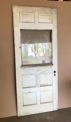 an old white door with a window in it