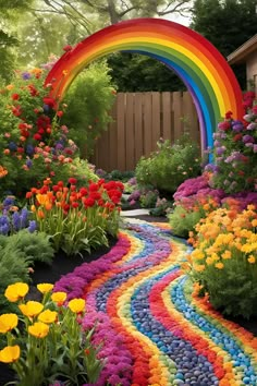 a garden with flowers and a rainbow colored path