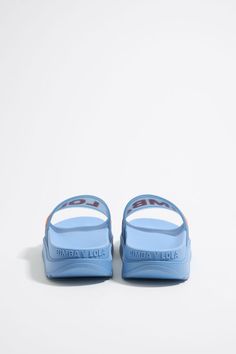 Blue platform flip-flop Summer Slide Sandals With Logo Print, Summer Slip-on Sandals With Logo Print, Logo Print Slip-on Sandals For Summer, Slip-on Sandals With Logo Print For Summer, Blue Slide Sport Sandals, Sporty Blue Slide Sport Sandals, Sporty Blue Slide Sandals, Blue Slide Flip Flops, Sporty Blue Sandals For Swimming