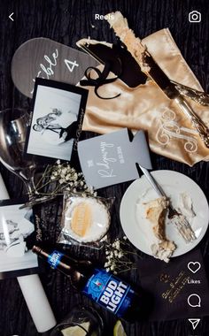 a table topped with plates and silverware next to bottles of alcohol on top of a wooden table