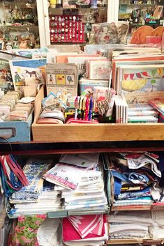 a drawer filled with lots of books and papers in front of a storefront window