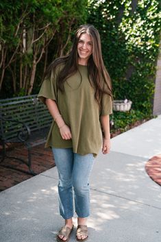 Unwind and relax in our Lounge Around Mineral Wash Oversize Tee in Moss. With a drop shoulder, short sleeves, and a relaxed fit, this tee is perfect for lounging at home or out on the town. The mineral wash gives it a unique look and feel, adding a touch of style to your comfort. The Fabric: 100% cotton Product Details: Relaxed, oversized fit. Mineral wash. Drop shoulder. Model shown wearing a size small. Green Relaxed T-shirt For Loungewear, Relaxed Green T-shirt For Everyday, Oversized Washed Tops For Day Out, Relaxed Cotton Short Sleeve Loungewear Top, Oversized T-shirt For Summer Casual Gatherings, Oversized Comfortable Everyday T-shirt, Relaxed Cotton Short Sleeve Top For Loungewear, Comfortable Short Sleeve T-shirt For Day Out, Casual Short Sleeve Top For Everyday Fall Wear