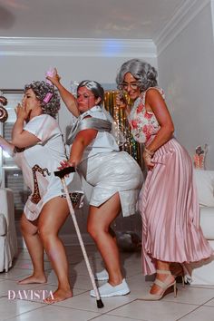 three women dressed in costumes posing for the camera