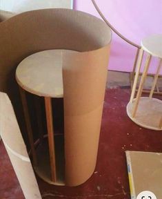 a table and chair made out of cardboard sitting on the floor next to each other