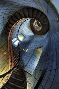 a spiral staircase in a building with tiled walls