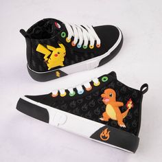 a pair of black and white shoes with pikachu on the front, pokemon on the back