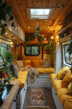 a small living area with yellow couches and potted plants