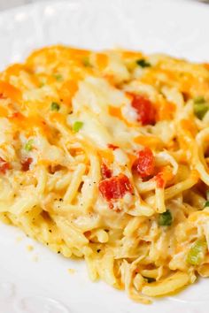 a white plate topped with pasta covered in cheese