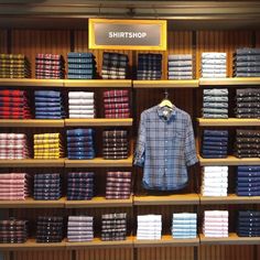 a shirt shop display with shirts on shelves