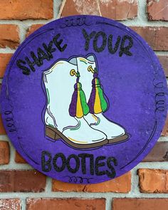 a purple sign that says shake your boots