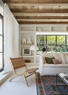 a living room filled with furniture and lots of windows