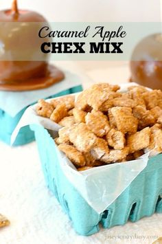 caramel apple chex mix in a blue container on a white table with apples