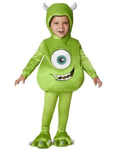 a little boy dressed in a green monster costume