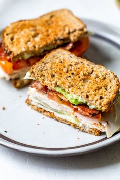 two sandwiches sitting on top of a white plate