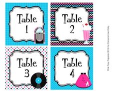 four place cards with different items on them for the table number one, two, and three