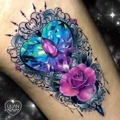 a colorful tattoo with flowers on the thigh and a heart shaped object in the middle