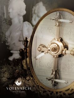 an ornately decorated mirror with the reflection of a statue in it's center