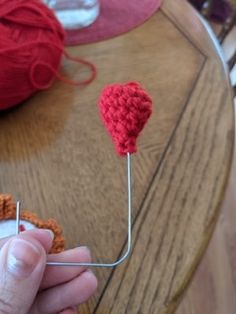 a person is knitting yarn on a skewer