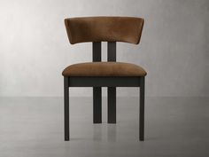 a brown chair sitting on top of a gray floor