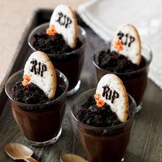 four dessert cups with halloween decorations in them