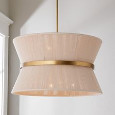 a light fixture hanging from the ceiling in a room with white walls and window behind it