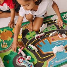 two children playing with toys on the floor