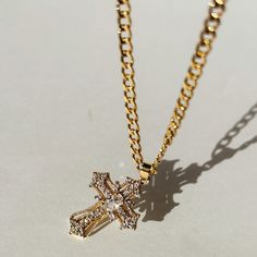 Our Miraculous Cross Necklace is the perfect symbol of faith and elegance. The cross pendant hangs on a stylish 14K Gold Filled curb chain. The Miraculous Cross Necklace is perfect for that statement piece you are looking to add to your collection.  Product Details 16" 3.5mm 14k Gold-Filled Curb Chain with 2" Extender Gold Cross Necklace With Diamond, Gold Crucifix Cross Necklace With Clavicle Chain, Gold Crucifix Necklace With Clavicle Chain, Elegant Cross Necklace With Adjustable Chain, Gold Cross Necklace With Adjustable Chain, Yellow Gold Cross Jewelry With Curb Chain, Gold-plated Cross Pendant Necklace With Chain, Adjustable Gold Plated Cross Pendant Necklace, Elegant Crucifix Cross Necklace With Chain