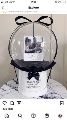 a snow globe with an anniversary card in it