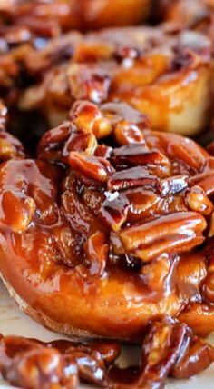 there are many donuts covered in caramel and nuts