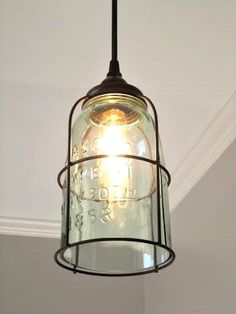 a mason jar hanging from the ceiling in a room with white walls and trimmings