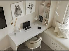 a white desk with a laptop computer on top of it