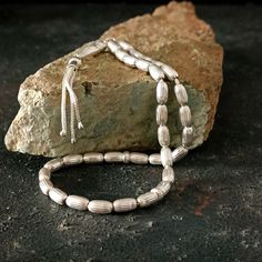 This is a 925 sterling silver item; It has different names such as rosary, prayer beads, misbah, sibha, tasbeeh. It is completely handmade, all parts including the rope are pure silver. This 33 beaded Islamic tasbih is a great Muslim gift idea. PRODUCT DETAILS Grain Shape: Barley Grain Length: 8mm (0.31") Grain Width: 5mm (0.19") All our products are handcrafted and carefully manufactured. The main principle of our store is to deliver quality products to our customers at affordable prices. You c Handmade Sterling Silver Beads For Jewelry Making, Handmade Sterling Silver Beads For Gift, Artisan Hand-strung Sterling Silver Beaded Bracelets, Artisan Silver Bracelet With Polished Beads, Handmade Silver Beaded Necklaces With Oval Beads, Spiritual Sterling Silver Bracelet With Spacer Beads, Spiritual Sterling Silver Beaded Bracelet With Spacer Beads, Silver Beaded Necklace With Round Beads, Traditional Silver Beaded Bracelets With Spacer Beads